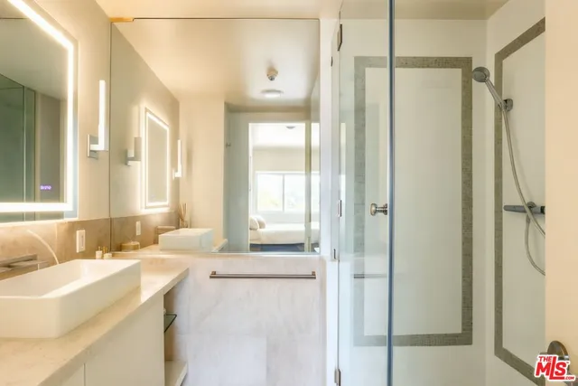 a bathroom with a tub sink and mirror