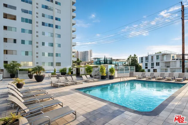 a view of a swimming pool with outdoor seating