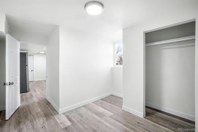 a view of a room with wooden floor
