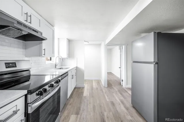 a kitchen with stainless steel appliances a sink and a stove