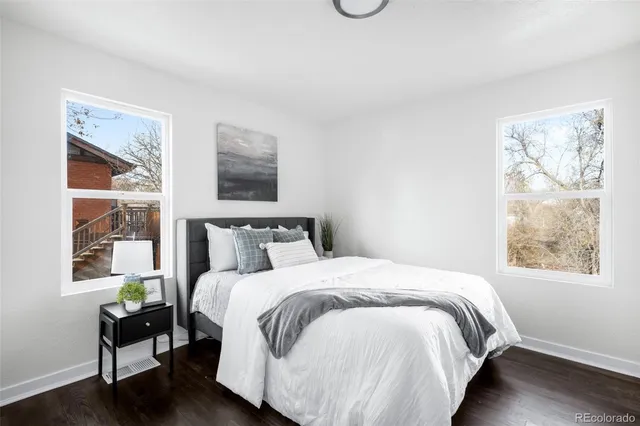 a large bed sitting in a bedroom next to a window