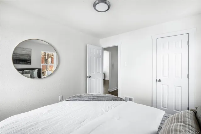 a bedroom with a bed and a mirror