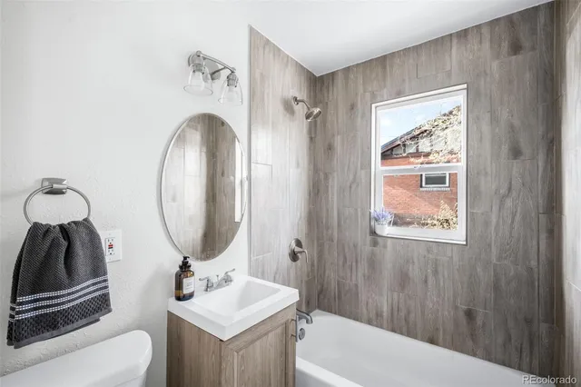 a bathroom with a sink a toilet and a mirror