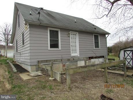 25250 Sotterley Road Hollywood, MD 20636 - Photo 2 of 20 a view of a house with a yard and wooden fence