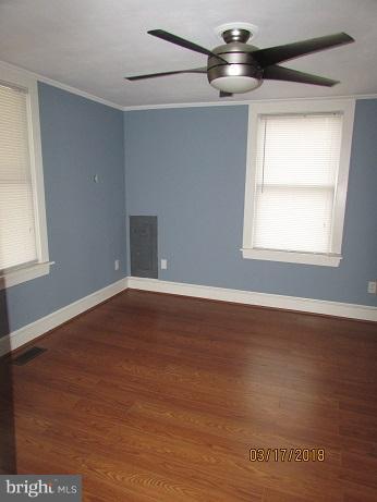 25250 Sotterley Road Hollywood, MD 20636 - Photo 12 of 20 a view of empty room with wooden floor and fan