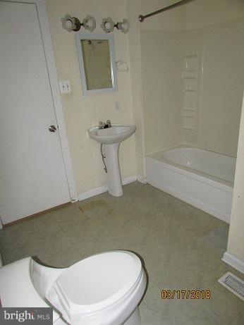 25250 Sotterley Road Hollywood, MD 20636 - Photo 16 of 20 a bathroom with a sink a toilet and bathtub