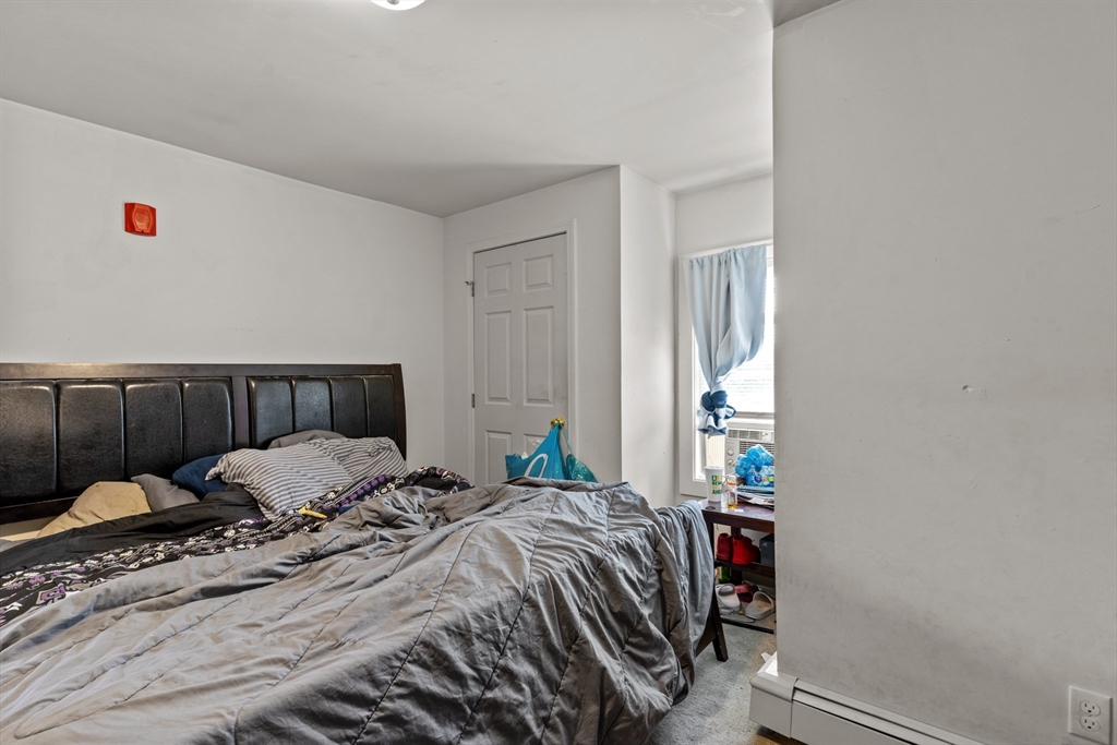 126 Earle Street Woonsocket, RI 02895 - Photo 12 of 42 a bedroom with a bed and a window