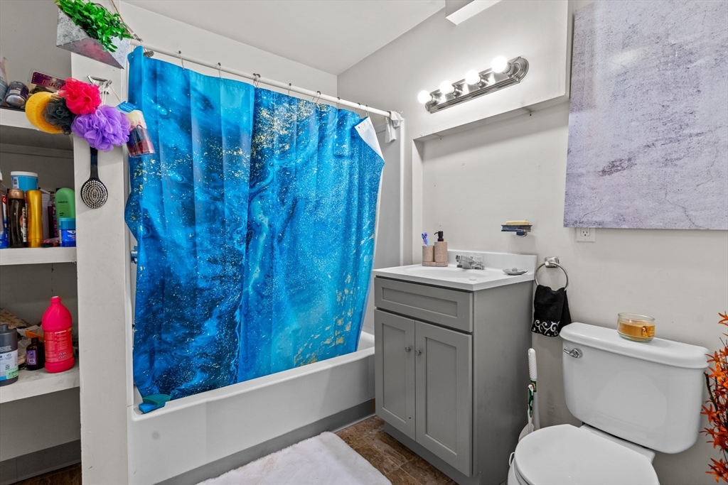 126 Earle Street Woonsocket, RI 02895 - Photo 16 of 42 a bathroom with a sink vanity mirror and toilet