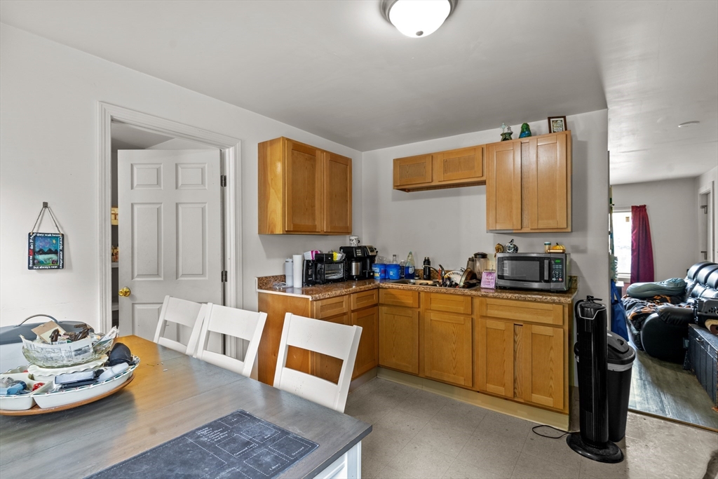 126 Earle Street Woonsocket, RI 02895 - Photo 20 of 42 a kitchen with stainless steel appliances granite countertop sink stove and cabinets