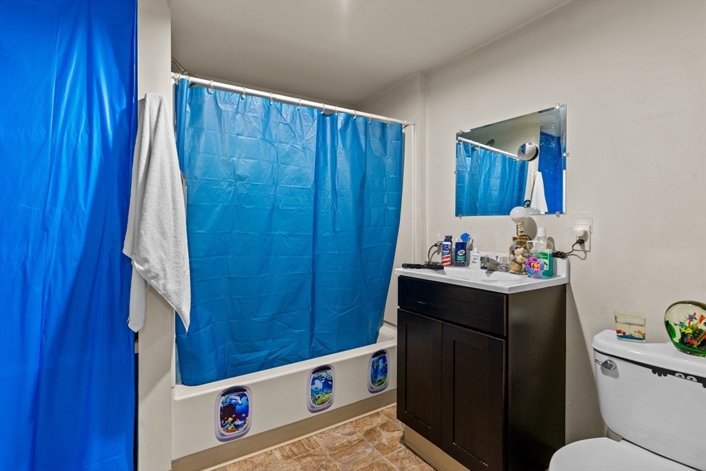 126 Earle Street Woonsocket, RI 02895 - Photo 29 of 42 a bathroom with a sink vanity mirror and toilet