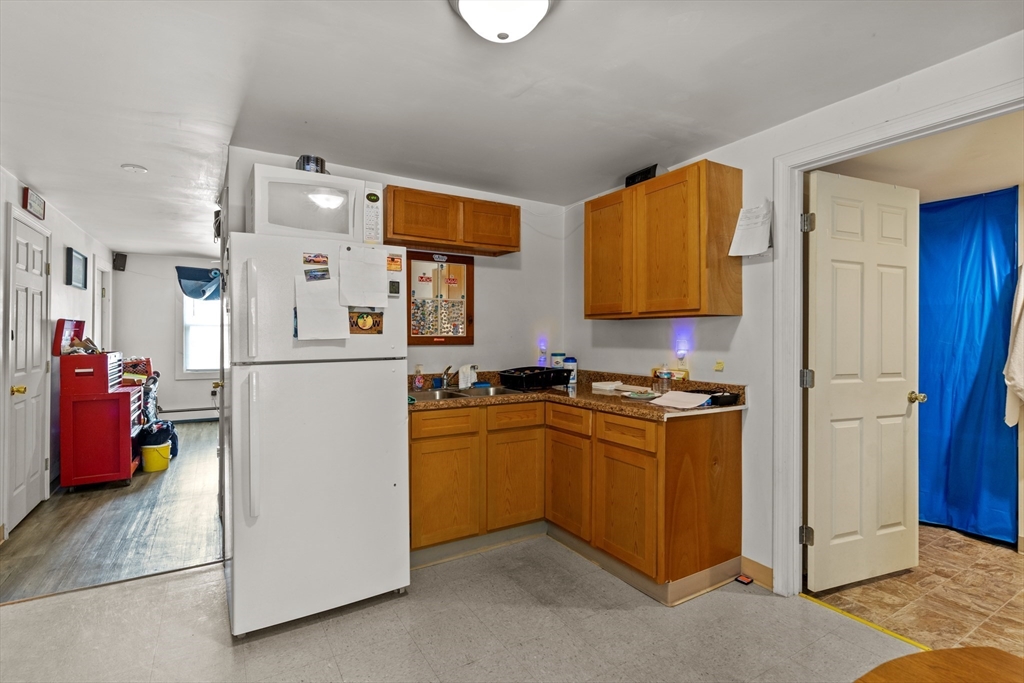 126 Earle Street Woonsocket, RI 02895 - Photo 30 of 42 a kitchen with a refrigerator and a sink