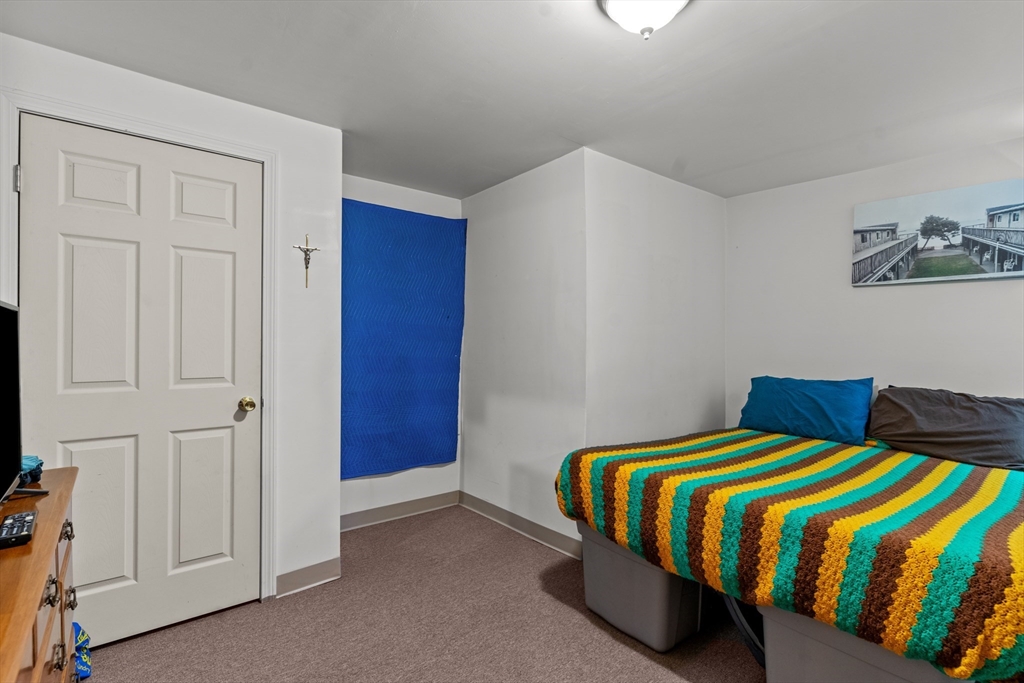 126 Earle Street Woonsocket, RI 02895 - Photo 32 of 42 a bedroom with a bed and painted walls