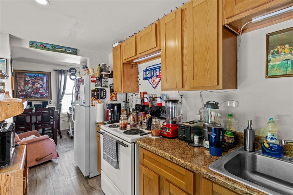 126 Earle Street Woonsocket, RI 02895 - Photo 34 of 42 a kitchen with a sink cabinets and wooden floor