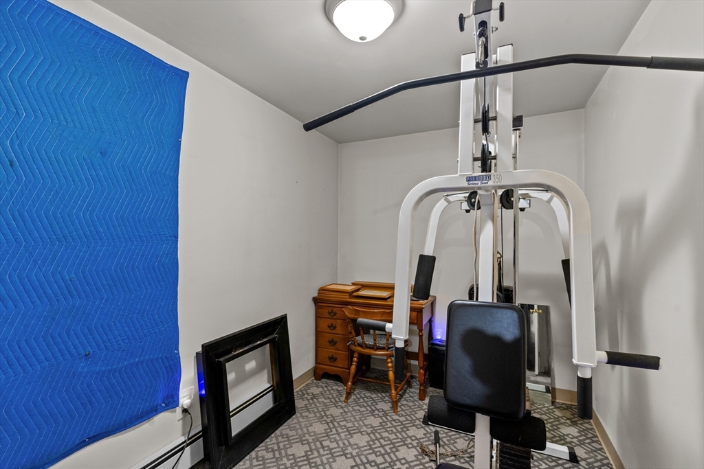 126 Earle Street Woonsocket, RI 02895 - Photo 38 of 42 a view of a hallway with wooden floor and staircase
