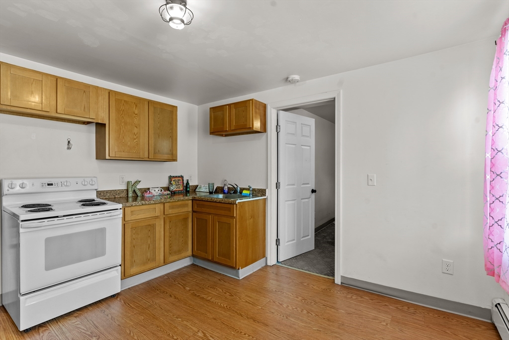 126 Earle Street Woonsocket, RI 02895 - Photo 5 of 42 a kitchen with stainless steel appliances granite countertop a stove and a refrigerator