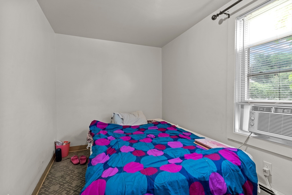 126 Earle Street Woonsocket, RI 02895 - Photo 8 of 42 a bedroom with a bed and a painting on the wall