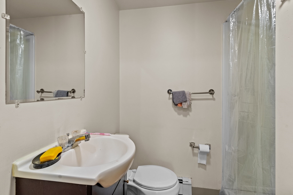126 Earle Street Woonsocket, RI 02895 - Photo 9 of 42 a bathroom with a sink a toilet and mirror