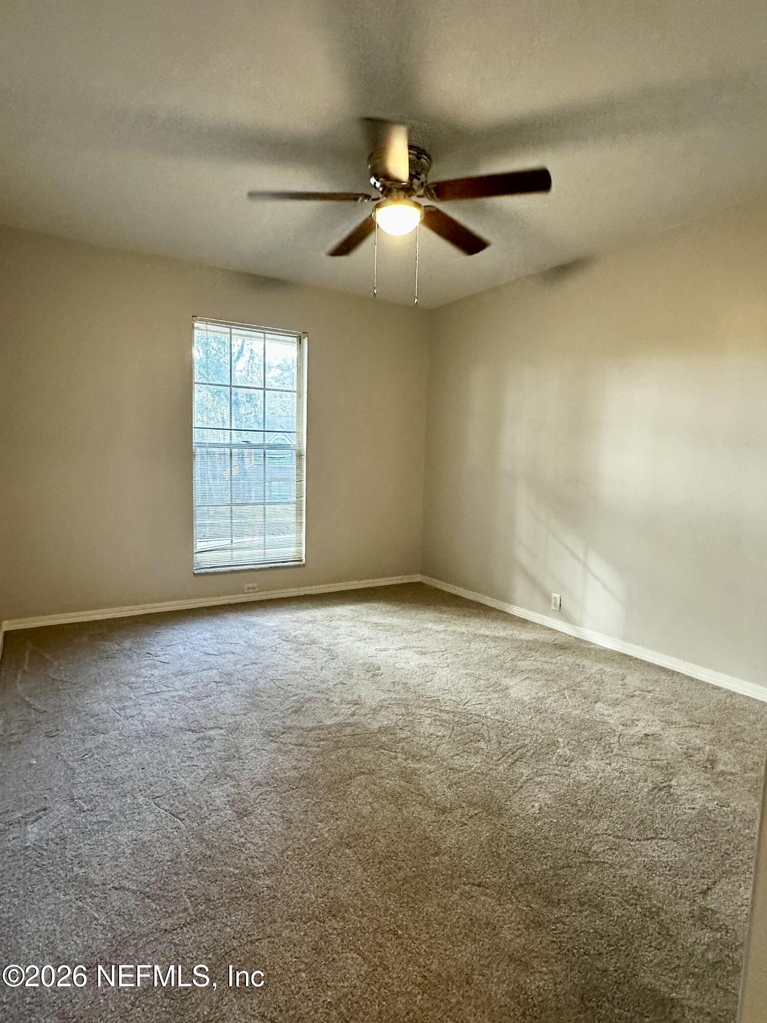 2245 Brentfield Road West Jacksonville, FL 32225 - Photo 11 of 21 an empty room with windows and fan