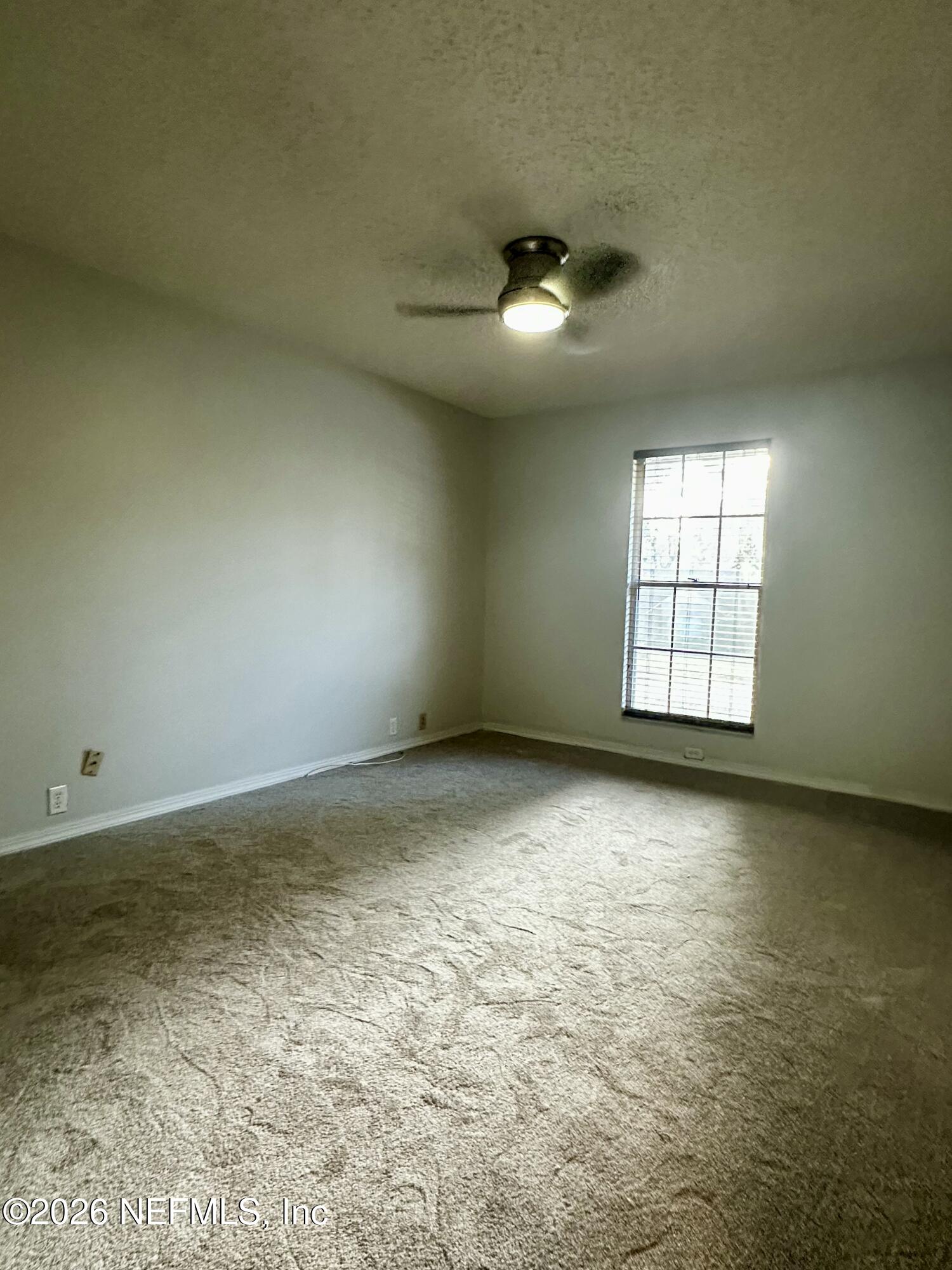 2245 Brentfield Road West Jacksonville, FL 32225 - Photo 12 of 21 an empty room with windows and ceiling fan view