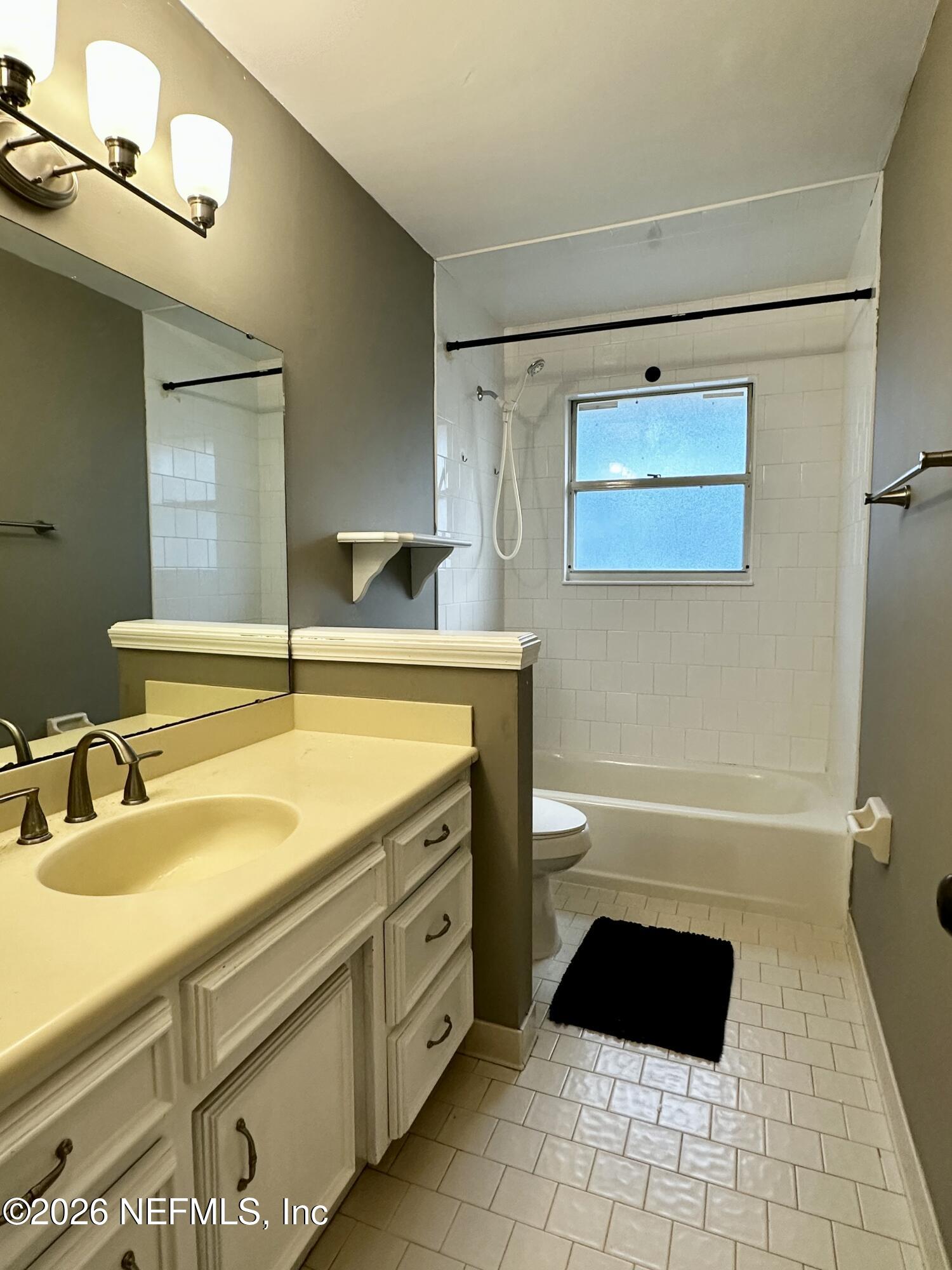 2245 Brentfield Road West Jacksonville, FL 32225 - Photo 13 of 21 a bathroom with a sink a toilet a mirror and bathtub