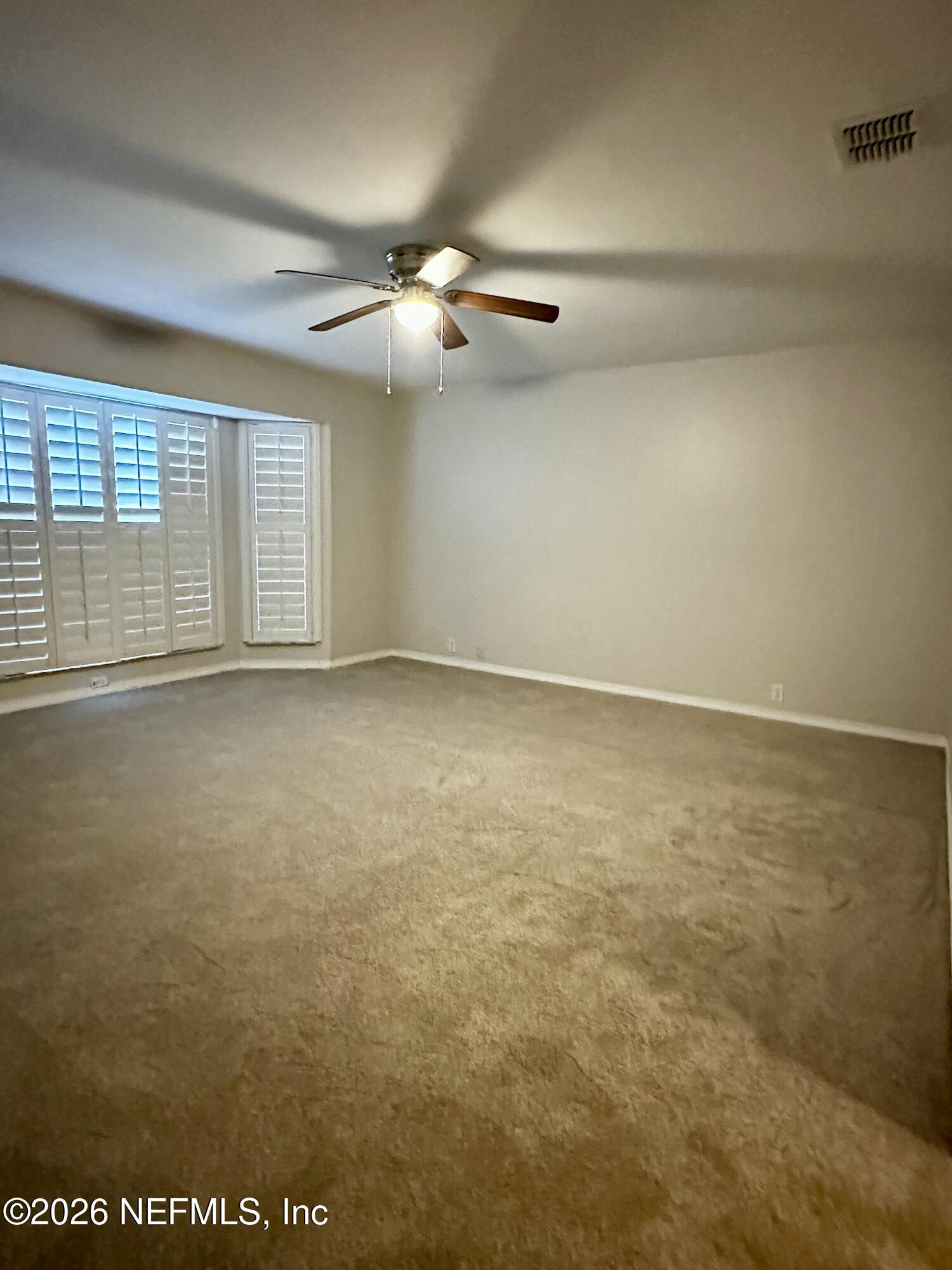2245 Brentfield Road West Jacksonville, FL 32225 - Photo 15 of 21 an empty room with windows and fan