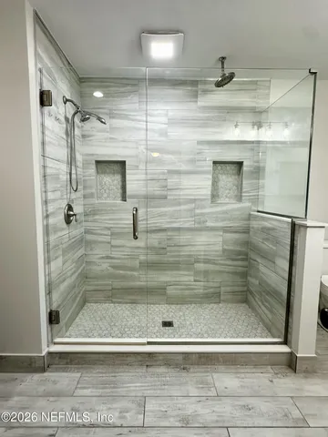 a bathroom with a double vanity sink a toilet and a mirror