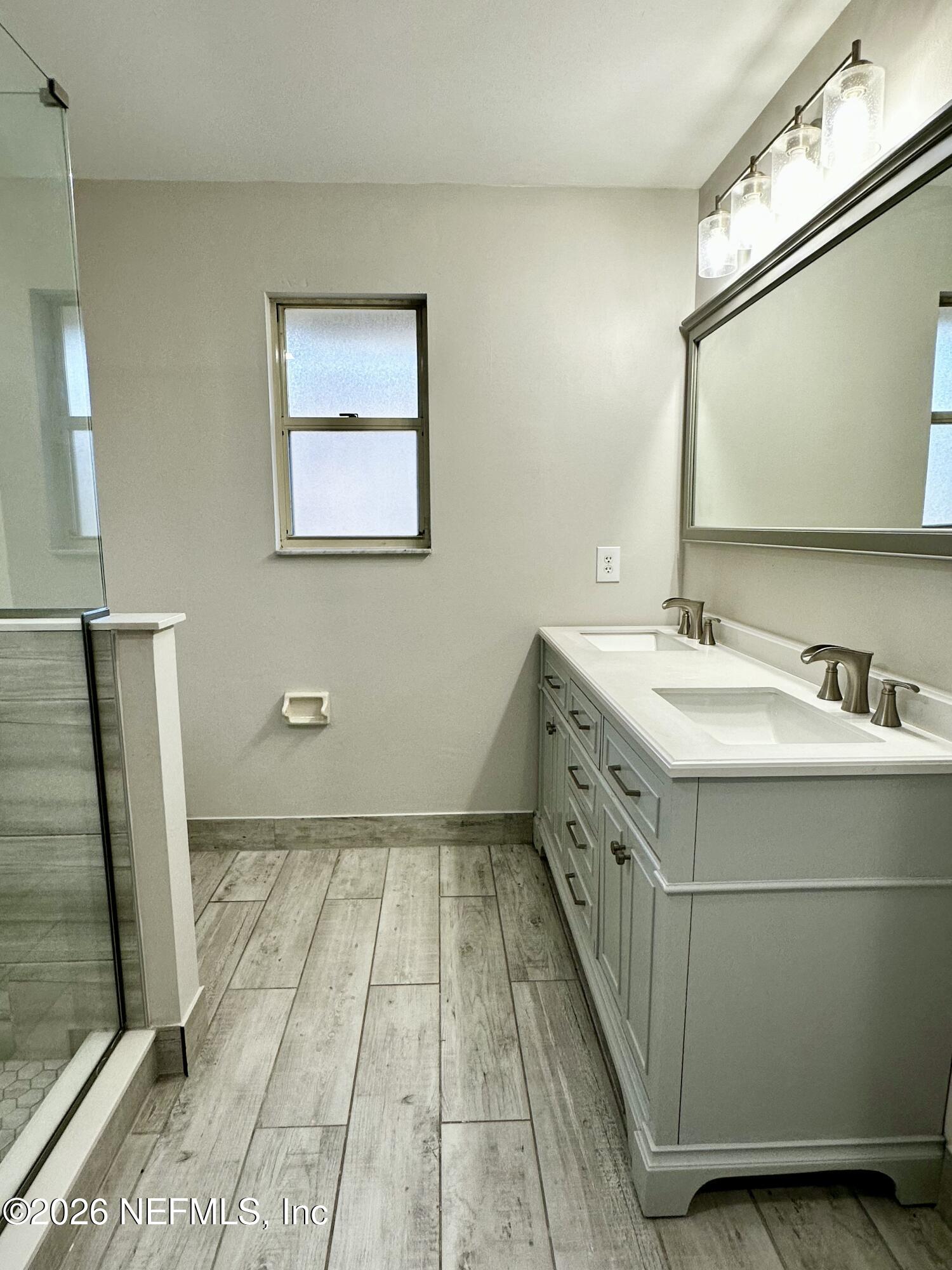 2245 Brentfield Road West Jacksonville, FL 32225 - Photo 17 of 21 a bathroom with a double vanity sink a toilet and a mirror