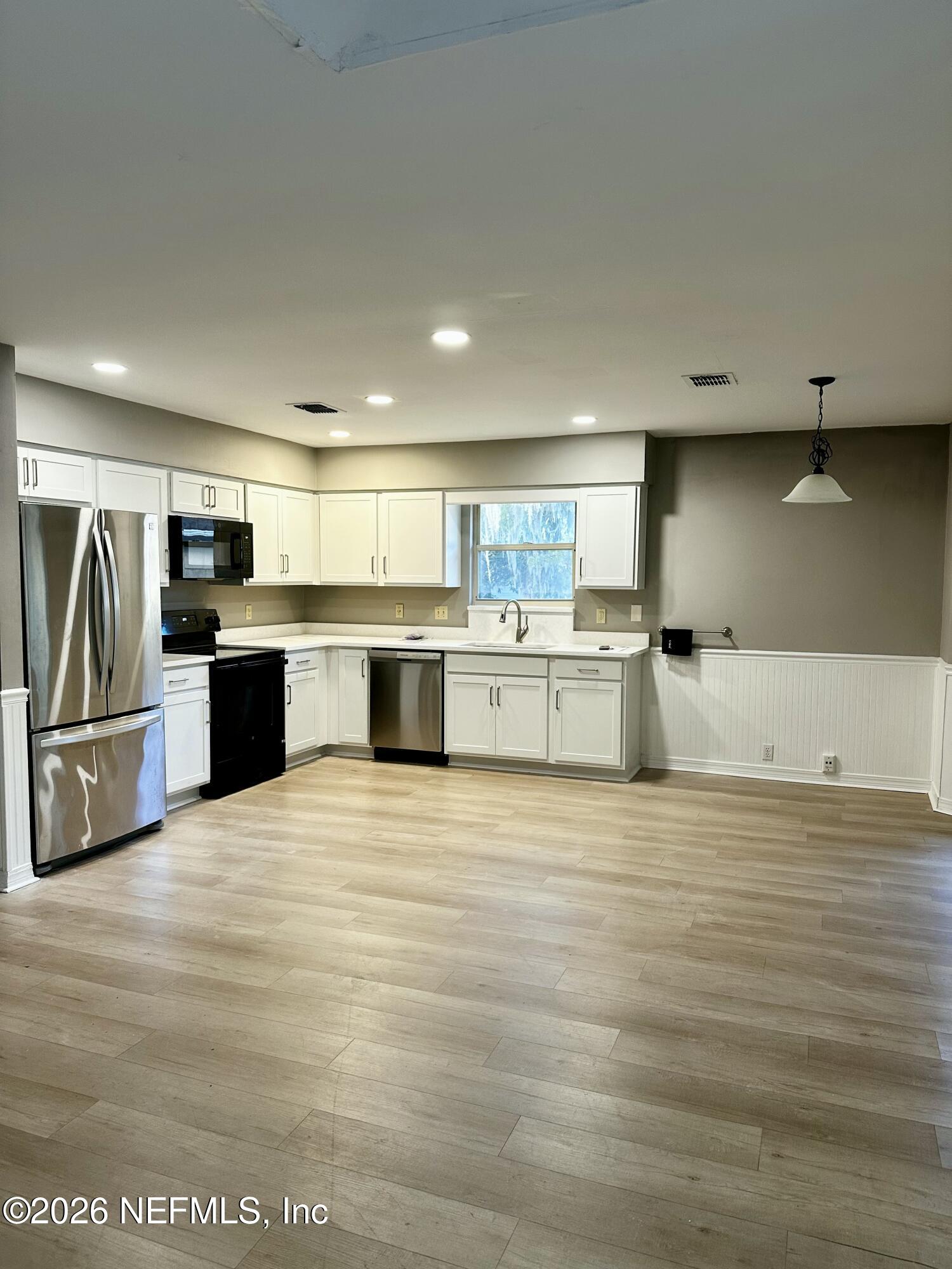 2245 Brentfield Road West Jacksonville, FL 32225 - Photo 4 of 21 a view of kitchen with stainless steel appliances wooden floor and view living room