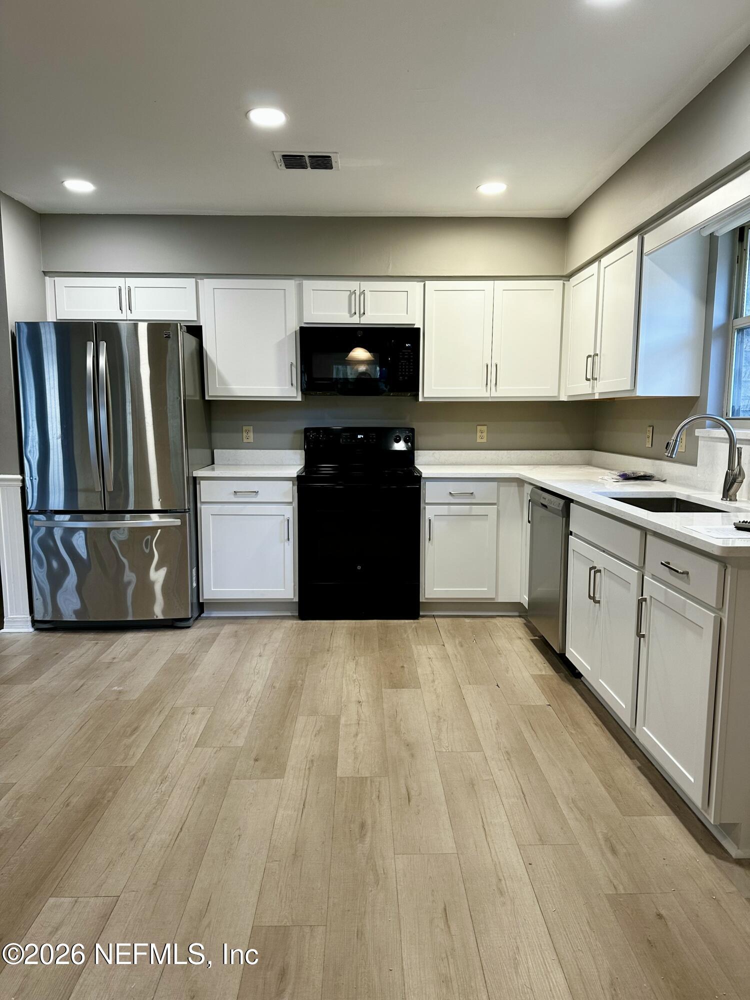 2245 Brentfield Road West Jacksonville, FL 32225 - Photo 7 of 21 a kitchen with a refrigerator and a sink