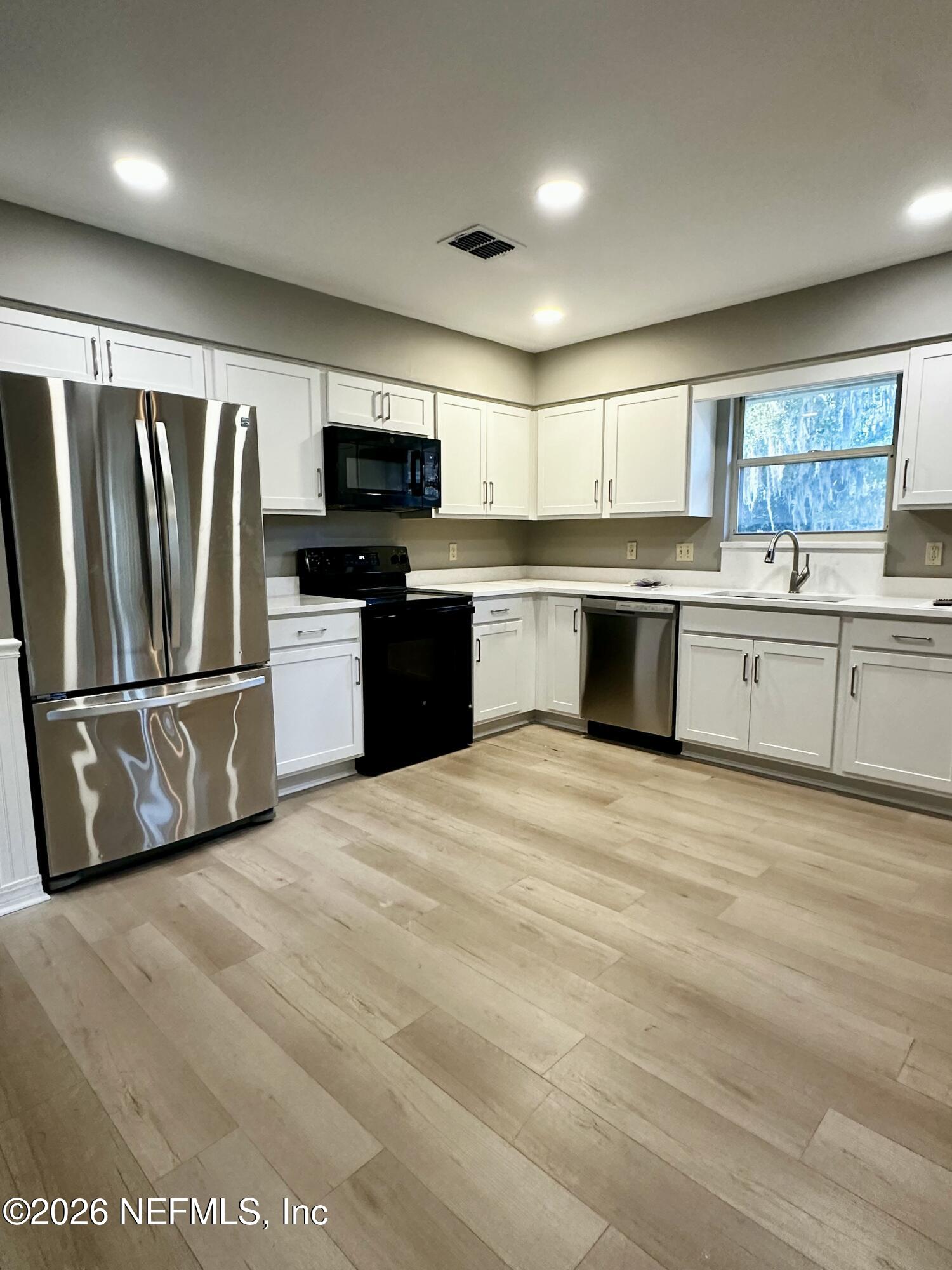 2245 Brentfield Road West Jacksonville, FL 32225 - Photo 8 of 21 a kitchen with stainless steel appliances granite countertop a refrigerator a stove a sink and a microwave