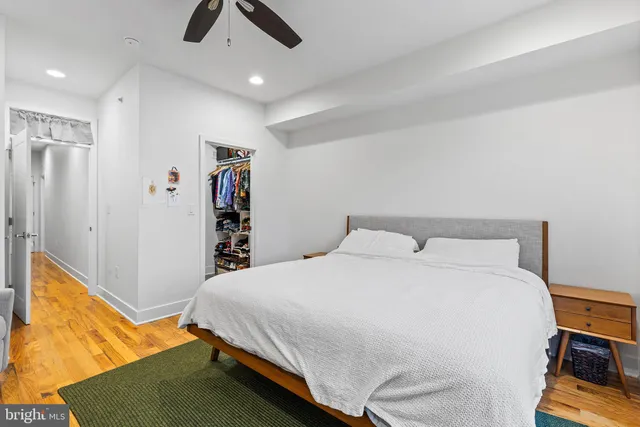 a bedroom with a bed and a flat tv screen