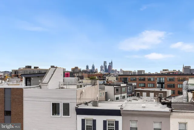 a view of a white building with a white roof