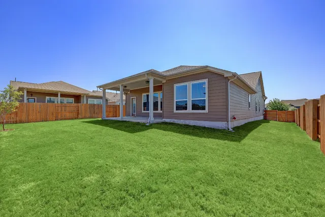 a view of a house with a backyard