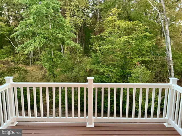 a view of a kitchen with kitchen island wooden floor and living room