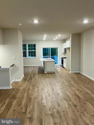 a kitchen with kitchen island a sink dishwasher and a refrigerator