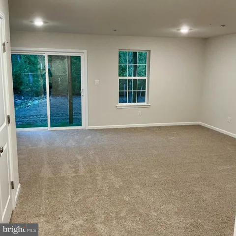 an empty room with large windows