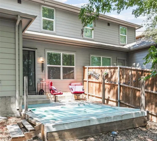 a white bench sitting in front of a house