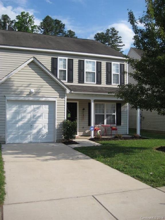 a front view of a house with garden and porch