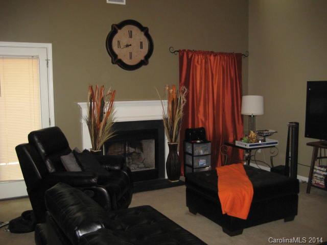 11024 Pointer Ridge Drive Charlotte, NC 28214 - Photo 5 of 8 a living room with furniture a fireplace and a large window