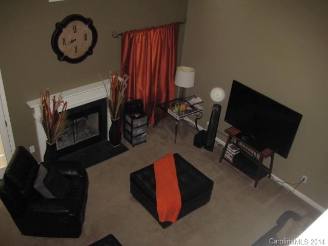 11024 Pointer Ridge Drive Charlotte, NC 28214 - Photo 6 of 8 a living room with furniture a flat screen tv and a wall clock