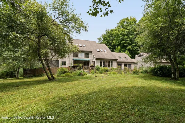 a front view of a house with yard and green space