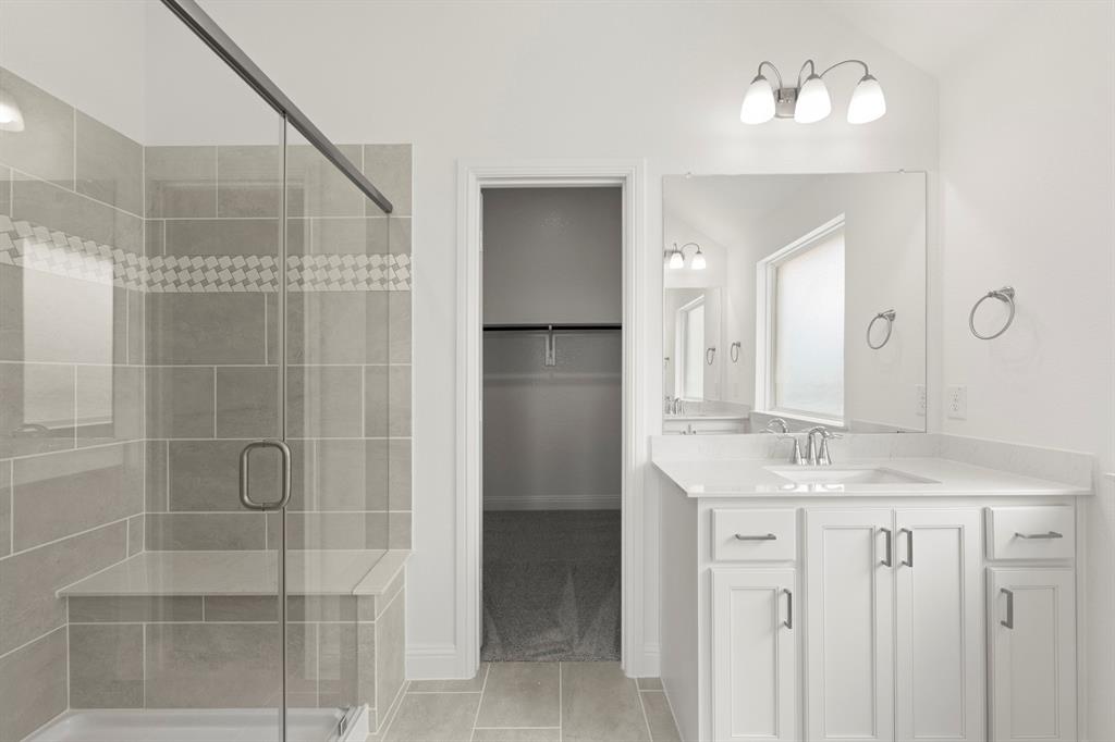 14551 Elion Court Pilot Point, TX 76258 - Photo 11 of 23 a bathroom with a shower sink and mirror