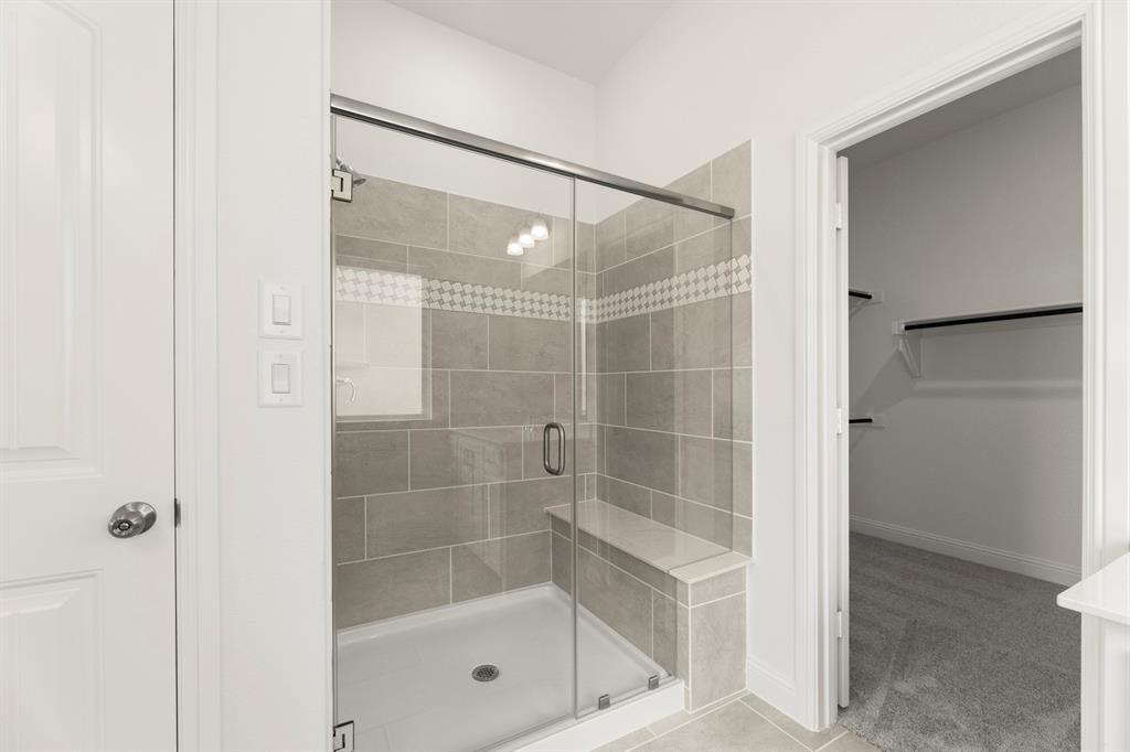 14551 Elion Court Pilot Point, TX 76258 - Photo 12 of 23 a bathroom with a glass shower door