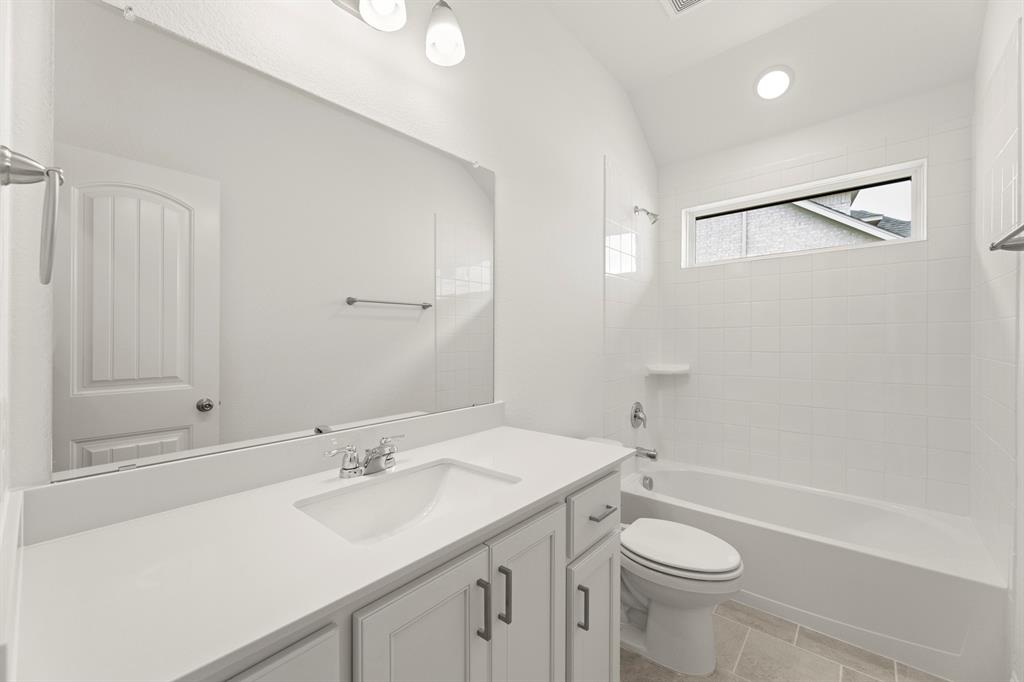 14551 Elion Court Pilot Point, TX 76258 - Photo 19 of 23 a bathroom with a sink a toilet and shower