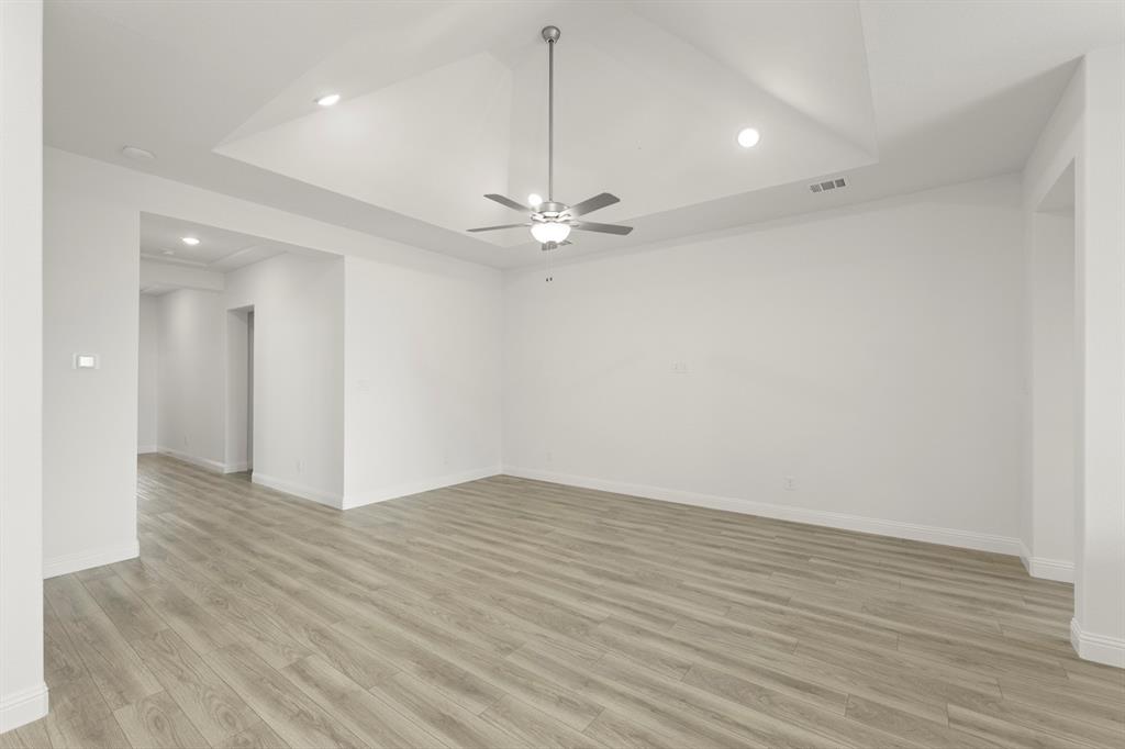 14551 Elion Court Pilot Point, TX 76258 - Photo 2 of 23 wooden floor in an empty room with a ceiling fan