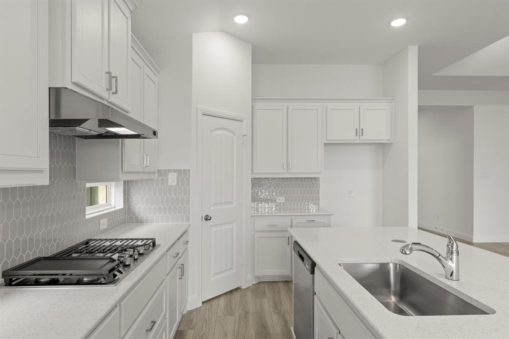 14551 Elion Court Pilot Point, TX 76258 - Photo 5 of 23 a kitchen that has a sink and a stove