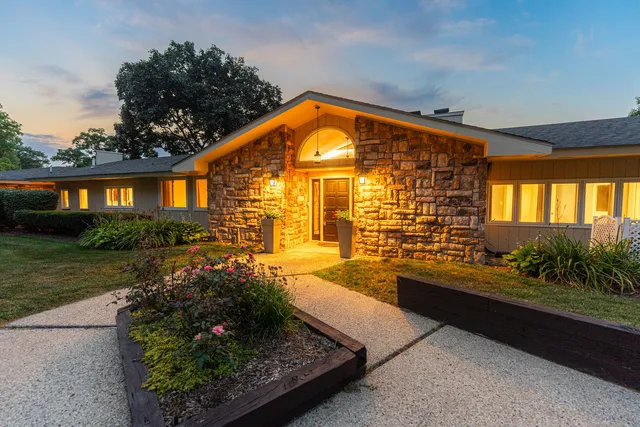 a backyard of a house with table and chairs