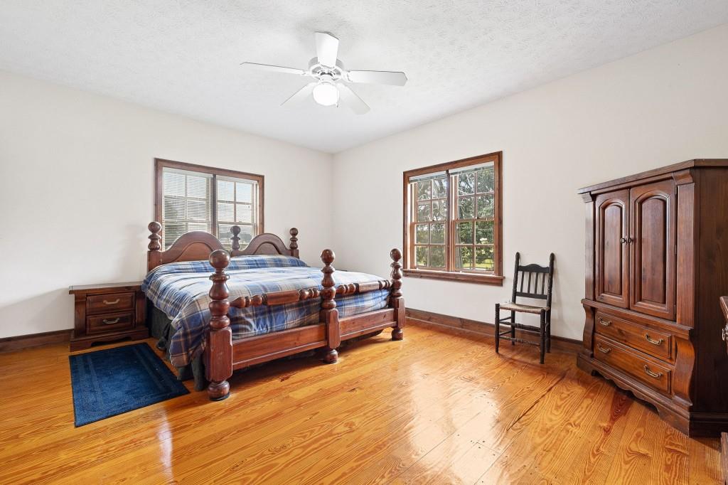 3780 Brownwood Road Madison, GA 30650 - Photo 14 of 25 a bedroom with a bed and a chandelier