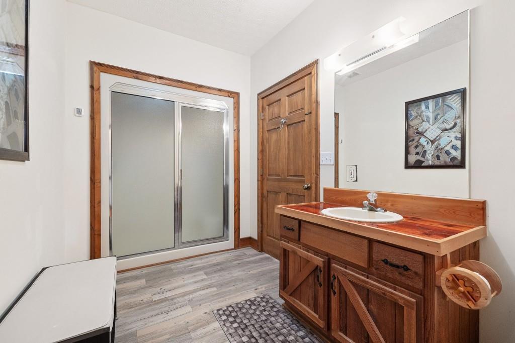 3780 Brownwood Road Madison, GA 30650 - Photo 15 of 25 a hall with a sink cabinets and wooden floor