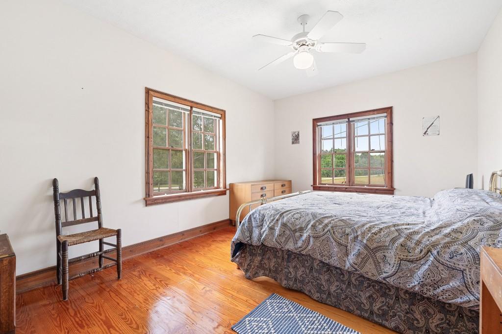 3780 Brownwood Road Madison, GA 30650 - Photo 16 of 25 a bedroom with a bed dresser and a window